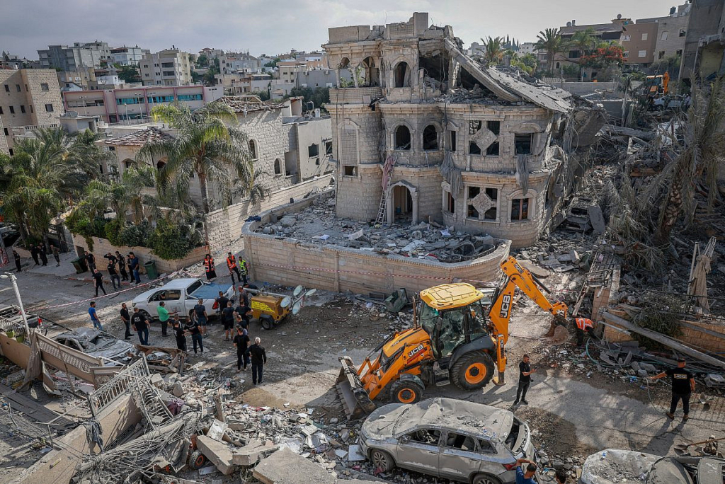 Missiles strike Israel, explosions rattle Iran as Middle East conflict enters third week